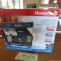 Front of sealed Honeywell safe box showing product image, brand and product features.