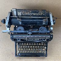 Top-down view showing Underwood logo on carriage, ribbon spools and carriage return lever