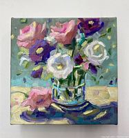 Front view of the oil painting showing the vibrant floral still life in a glass vase with pink, white, and purple flowers.