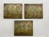 Photo showing three small canvas paintings arranged on a white surface, each depicting trees with green and yellow foliage casting shadows