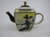 Side view of the miniature enamel teapot showing detailed enamel artwork with figures and a yellow background, black spout, and gold-trimmed handle