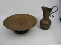 Full view of hand hammered copper pedestal plate and jug, showing size and form.