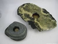 Top view of two natural stone ikebana vases showing color and metal flower holders