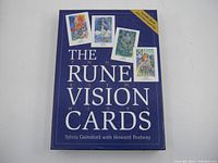 Photo of the front of the boxed deck with card illustrations and title