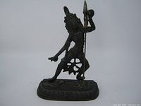 Front view of the metal Hindu goddess Kali statue showing dynamic pose and spear.