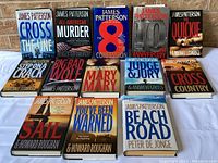 Photo shows the full lot of 13 hardcover James Patterson books with jackets visible, titles displayed in rows.