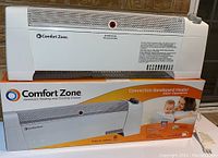 Front view of the Comfort Zone convection baseboard heater on top of the product box showing brand and model details.