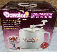 Box showing brand, model and product image with wear visible on box edges.