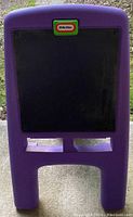 Photo of the purple Little Tikes kids chalkboard easel front showing black chalkboard surface with Little Tikes logo at top.
