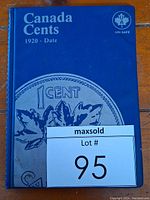 Blue hard cover collector's album titled 'Canada Cents 1920-Date' with Uni-Safe logo on front cover