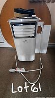 Front view of Comfee portable air conditioner showing white unit with front adjustable air vents and power cord.