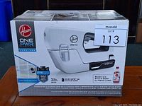 Front view of the Hoover OnePWR cordless handheld rechargeable sprayer box showing the product, brand, and some features.