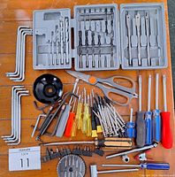 Full layout of all tools including drill bit case, hex keys, screwdrivers, pliers, scissors, and other hand tools.