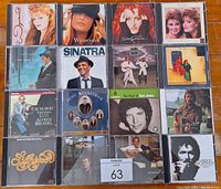 Full lot of 16 CDs arranged in 4 rows, showing cover art of various artists including Wynonna, The Judds, Frank Sinatra, Gordon Lightfoot, Schubert, Ross Woolridge and Tom Jones.
