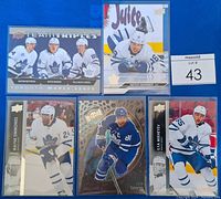 Photo showing all 5 Toronto Maple Leafs hockey cards including the Team Triples insert featuring Auston Matthews, Mitch Marner, and William Nylander.