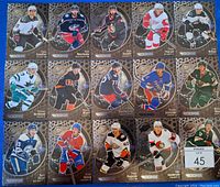 Photo of 15 Metal Universe rookie cards showing full lot with players in action poses, team logos, and metallic backgrounds.