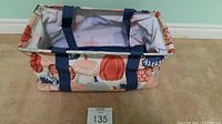 Fall pumpkin design medium utility tote with wire support, standing on carpeted floor.