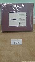 Photo of brand new sealed Martex Home twin 3-piece sheet set in lilac color with packaging label