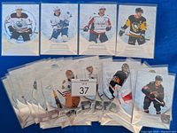Overview of multiple Upper Deck Credentials hockey cards arranged on blue background, showing different players including Sidney Crosby, Connor McDavid, Mitch Marner, Alex Ovechkin, among others.