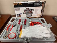 Photo showing the contents of the emergency roadside kit plastic case with tools and accessories.