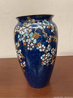 Front view of the Royal Winton Grimwades vase showing blue background with dense blossom branch decoration.