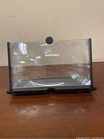 Front view of the screen magnifier with stand showing the transparent curved magnifying lens.