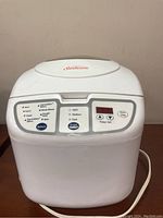 Front view of Sunbeam bread maker showing control buttons and digital timer display.