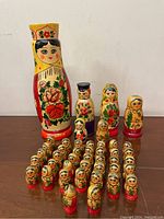 Full group of over 40 vintage handmade Russian Matryoshka dolls arranged in rows, includes large Rodnik vodka shaped doll and smaller traditional dolls.