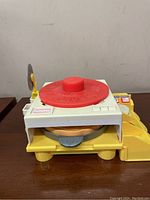 Front view of the toy revealing the working dial and front access.