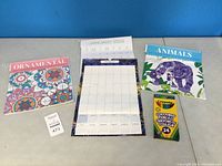 Overview of the two adult colouring calendars (Animals and Ornamental) and unopened Crayola coloured pencils box 24 pack.