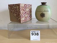 Green spherical ceramic candle holder with brown flower decoration and inscription 'A true friend is forever'.