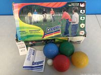 Cooper bocce ball set with four colored balls, pallino ball, original box with player image.
