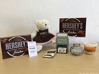 Front view of the Hershey's chocolate fondue box with small stuffed bear, calendar block, glass jar, chocolate square and baking cup