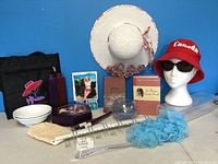 Wide shot of the lot showing various items including hats, cookbooks, decor, and household items.