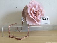 Front side view of small young girls shoulder purse with large fabric pink flower and rose gold chain strap.