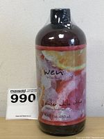 Front view of the 16oz amber plastic bottle of WEN Cleansing Hair Conditioner in Winter White Citrus scent with colorful citrus-themed label and shrink-wrapped black cap.