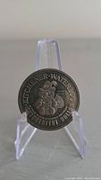 Obverse of the 1974 Kitchener Waterloo Oktoberfest dollar token showing cartoon figure with beer stein and festival logos.