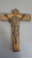 Front view of the antique wooden crucifix showing the Jesus figure affixed to the cross.