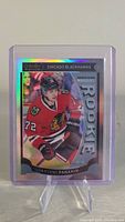 Front of the 2015-16 O-Pee-Chee Platinum Artemi Panarin Rookie Rainbow card in protective sleeve