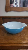 Front view of the large vintage Pyrex mixing bowl showing one handle and blue exterior