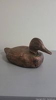 Side view of the wooden duck decoy showing profile and finish.
