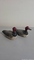 Pair of wood decoy ducks showing bodies and painted detail