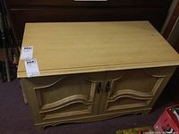 Front view of the vintage Dellcraft wooden chest showing top surface and front decorative doors with handles.