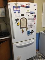 Front view of white GE refrigerator with bottom freezer drawer
