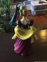 Photo of Loretta figurine from the back showing intricate dress and hairstyle