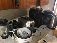 Full view of all six small kitchen appliances placed on countertop