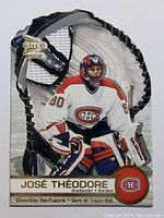Front view of the Jose Theodore hockey card showing player image, team colors, and glove fusion design.