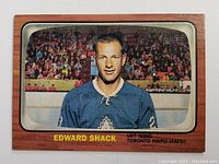 Front of the 2002 Edward Shack re-issued classic hockey card showing player portrait in Toronto Maple Leafs jersey and wood-grain border.