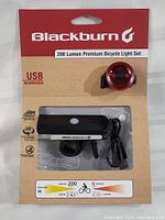 Front view of Blackburn bike light set packaging showing front and rear lights, USB rechargeable feature, and specifications.