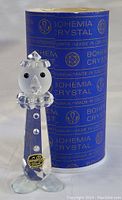Clear faceted Bohemia crystal clown figurine with distinct black eyes, nose, ruffled collar and hat. Displayed in front of original blue Bohemia Crystal box with gold lettering and logo.